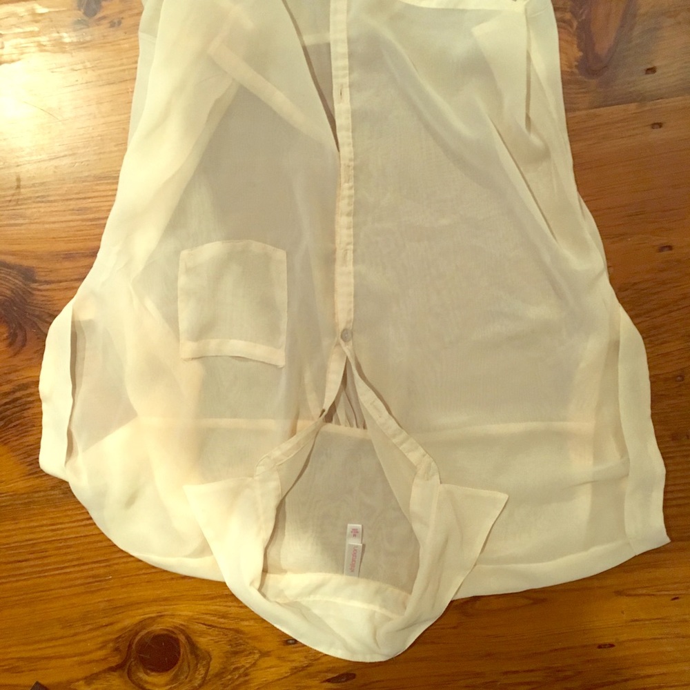 Thin, cream-colored collared shirt